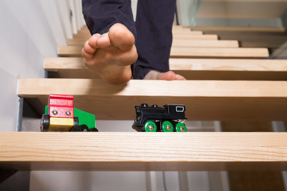 man treading wooden trains stairs