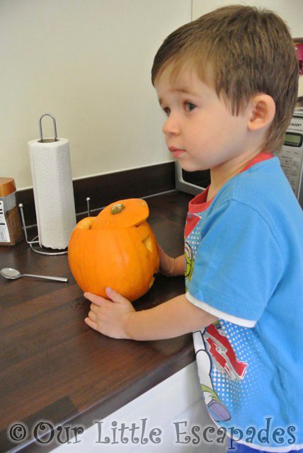 ethan watching pumpkin carving halloween 2013