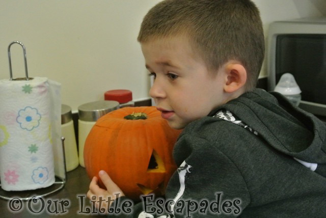 ethan watching pumpkin carving halloween 2014