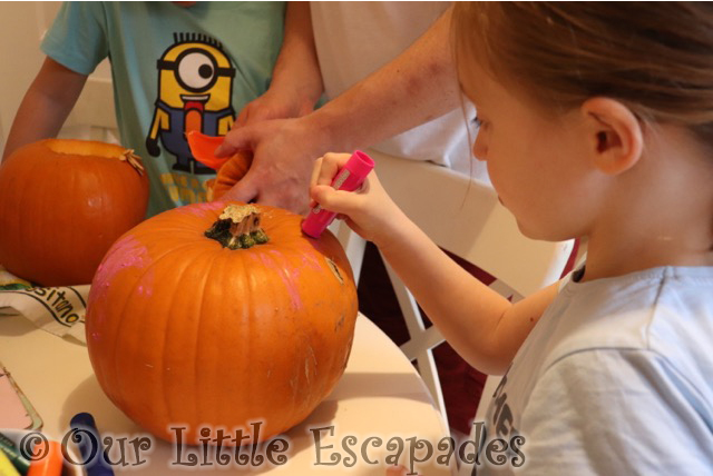 little e painting her pumpkin pink