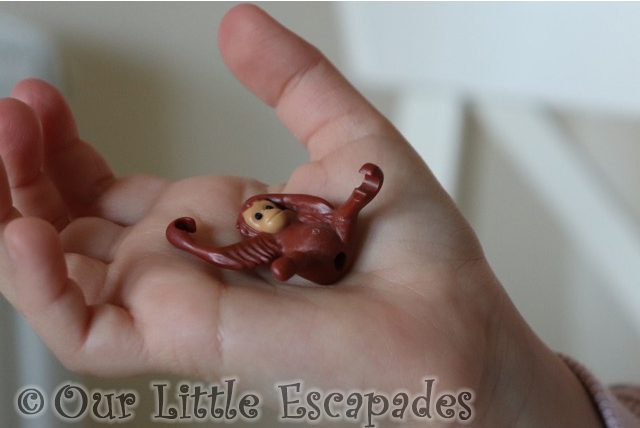 little e holding orangutan baby