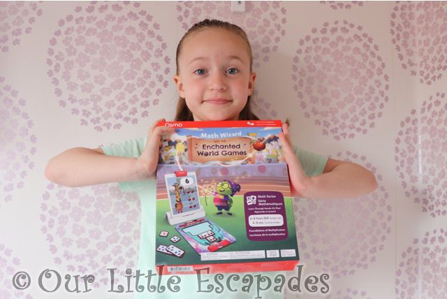 little e holding osmo math wizard enchanted world games box