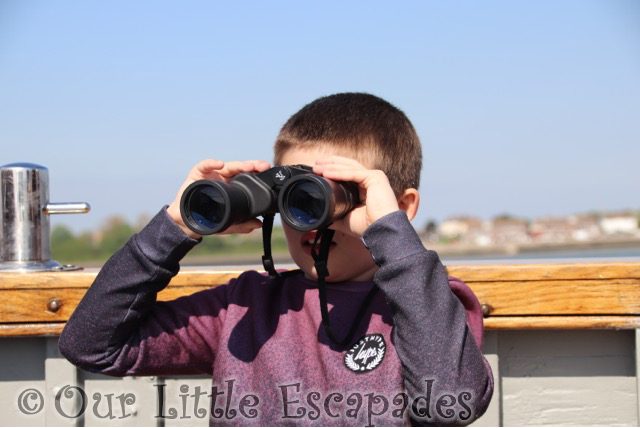 ethan looking through binoculars harwich seal trip