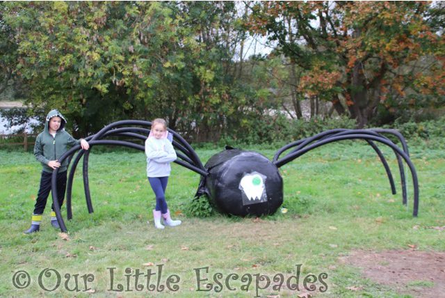 ethan little e standing with large spider prettyfields pumpkin patch October 2021