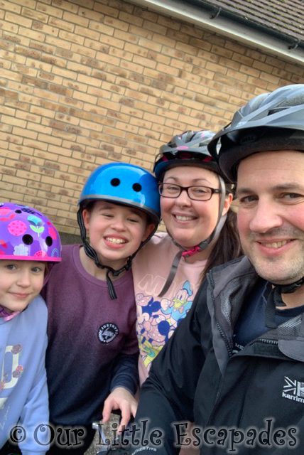 family selfie wearing cycle helmets