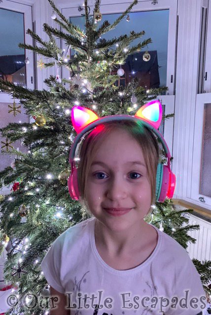 little e wearing cat ear light up headphones