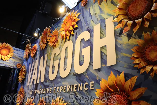 van gogh immersive experience entrance sign sunflower wall