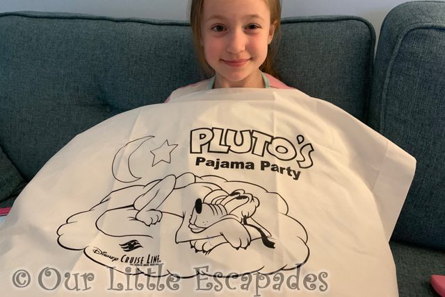 little e holding plutos pajama party pillowcase
