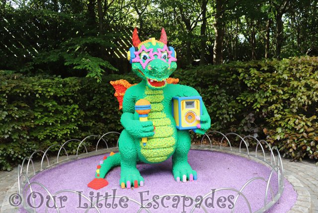green lego dragon wearing purple star sunglasses legoland windsor