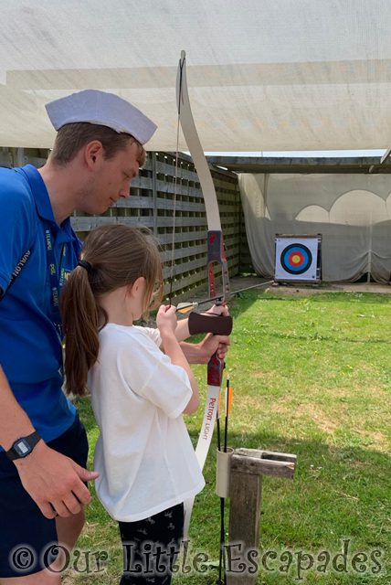 little e pgl activity instructor helping archery pgl family holiday