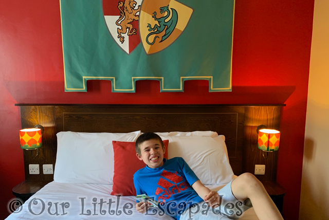 smiling ethan laying double bed kingdom room legoland windsor hotel